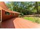 Spacious backyard deck, brick home exterior, lush green yard and rock wall, perfect for outdoor entertaining at 2279 Parkview Cir, College Park, GA 30337
