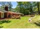 Spacious backyard with lush green grass, mature trees, and a deck ideal for entertaining at 2279 Parkview Cir, College Park, GA 30337