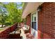 Outdoor patio with brick surround, cushioned furniture, and mature trees surrounding the property at 2279 Parkview Cir, College Park, GA 30337