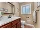 Neutral bathroom with a single sink vanity, framed mirror, ceramic tile flooring, and a decorative towel bar at 2279 Parkview Cir, College Park, GA 30337