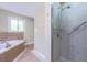 Bathroom featuring walk-in shower with safety bars and separate soaking tub beneath a window at 2279 Parkview Cir, College Park, GA 30337