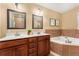 Primary bathroom featuring tile walls, soaking tub, and double sink vanity with tile floors at 2279 Parkview Cir, College Park, GA 30337