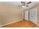 Simple bedroom features hardwood floors, a ceiling fan, and neutral walls, creating a peaceful and inviting atmosphere at 2279 Parkview Cir, College Park, GA 30337