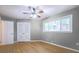 Bedroom with hardwood floors, ceiling fan, a window, and white closet doors at 2279 Parkview Cir, College Park, GA 30337