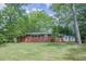 Charming single-story brick home surrounded by mature trees and a spacious front yard at 2279 Parkview Cir, College Park, GA 30337