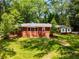 Charming single-story brick home surrounded by mature trees and a well-maintained lawn at 2279 Parkview Cir, College Park, GA 30337