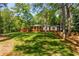 Single-story home featuring red brick and white exterior and a lush green lawn and mature trees at 2279 Parkview Cir, College Park, GA 30337