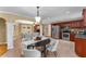 Eat-in kitchen features stainless steel appliances, granite counters, tile flooring, and a view to the living room at 2279 Parkview Cir, College Park, GA 30337