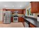 The kitchen features stainless steel appliances, a dark countertop, and dark-stained wooden cabinets at 2279 Parkview Cir, College Park, GA 30337