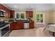 View of the eat-in kitchen with stainless steel appliances and wooden cabinets, open to the dining area at 2279 Parkview Cir, College Park, GA 30337