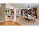Open-concept living area with a dining space, tile floor, and a brick fireplace at 2279 Parkview Cir, College Park, GA 30337