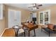 Bright home office features a ceiling fan, hardwood floors, a desk, and seating, creating a functional workspace at 2279 Parkview Cir, College Park, GA 30337