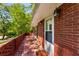 Cozy brick-paved patio with charming brick railing and a view of the lush green lawn at 2279 Parkview Cir, College Park, GA 30337