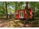 Cozy backyard with a red shed that has windows and French doors surrounded by lush greenery at 2279 Parkview Cir, College Park, GA 30337