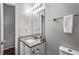 Bathroom featuring granite countertop, updated fixtures, and a decorative mirror at 2738 Lakewater Way, Snellville, GA 30039