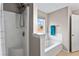 Well-lit bathroom with white tub, and natural light from window at 2738 Lakewater Way, Snellville, GA 30039