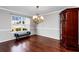 Bright dining room with hardwood floors, elegant chandelier, and neighborhood views at 2738 Lakewater Way, Snellville, GA 30039