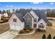 Charming two-story home with stone accents, a well-manicured lawn, and a two-car garage at 2738 Lakewater Way, Snellville, GA 30039
