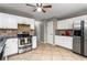 Bright kitchen features stainless appliances, granite counters, and ample cabinet space at 2738 Lakewater Way, Snellville, GA 30039