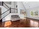 Open-concept living area with hardwood floors, staircase, and large windows at 2738 Lakewater Way, Snellville, GA 30039