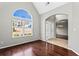 Elegant living room featuring a large window, hardwood floors, and an arched entryway at 2738 Lakewater Way, Snellville, GA 30039