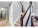 Carpeted staircase with white railings and dark wood accents leading to the upper level at 2738 Lakewater Way, Snellville, GA 30039