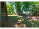 View of a shady backyard bordered by mature trees at 28 Indian Branch Way, Lawrenceville, GA 30043