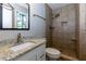 This bathroom features tiled shower, granite countertop, and modern fixtures at 28 Indian Branch Way, Lawrenceville, GA 30043