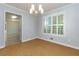 Inviting dining room with stylish light fixture, wood floors, and abundant natural light from shuttered windows at 28 Indian Branch Way, Lawrenceville, GA 30043