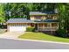 Charming two-story home boasts a brick front, attached garage, a welcoming porch, and a lush green yard at 28 Indian Branch Way, Lawrenceville, GA 30043