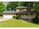 Charming two-story home boasts a brick front, attached garage, a welcoming porch, and a meticulously maintained lawn at 28 Indian Branch Way, Lawrenceville, GA 30043