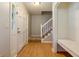 Welcoming foyer showcasing hardwood floors, a staircase, and a built-in bench for added convenience at 28 Indian Branch Way, Lawrenceville, GA 30043