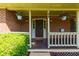 Inviting front porch adorned with hanging flower baskets, brick facade, and a 'Welcome' mat at 28 Indian Branch Way, Lawrenceville, GA 30043