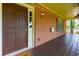 Inviting front porch featuring a brick facade, decorative flower baskets, and a classic dark wood door at 28 Indian Branch Way, Lawrenceville, GA 30043