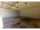 Spacious, empty two car garage with concrete floor and automatic door at 28 Indian Branch Way, Lawrenceville, GA 30043