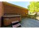 Outdoor hot tub on wooden deck, set against a brick exterior at 28 Indian Branch Way, Lawrenceville, GA 30043