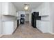 Spacious kitchen with white cabinetry, modern appliances, and a view to adjacent rooms for easy entertaining at 28 Indian Branch Way, Lawrenceville, GA 30043
