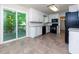 Bright kitchen with white cabinets, stainless steel appliances, and sliding glass doors to the deck at 28 Indian Branch Way, Lawrenceville, GA 30043