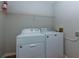 Functional laundry room with white washer and dryer, complemented by overhead shelving at 28 Indian Branch Way, Lawrenceville, GA 30043
