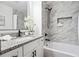 Elegant bathroom featuring marble tile, a modern vanity, and a luxurious soaking tub at 3708 Canadian Way, Tucker, GA 30084