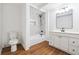 Updated bathroom features a vanity, mirror, toilet, and shower with contemporary fixtures and new tile work at 3708 Canadian Way, Tucker, GA 30084