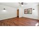 Bright bedroom features hardwood floors, neutral walls, and a ceiling fan, illuminated by natural light from a large window at 3708 Canadian Way, Tucker, GA 30084