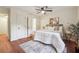 Serene bedroom with natural light, complemented by modern decor and a ceiling fan at 3708 Canadian Way, Tucker, GA 30084