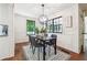 Bright dining room features black window trim, a modern light fixture, and hardwood floors at 3708 Canadian Way, Tucker, GA 30084