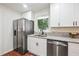 Modern kitchen with stainless steel appliances, a granite countertop, and white cabinets at 3708 Canadian Way, Tucker, GA 30084