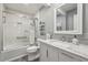 Bright bathroom featuring a tub with shower and marble countertops at 407 River Mill Cir # 407, Roswell, GA 30075