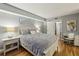 Bright primary bedroom featuring hardwood floors, with a neutral grey color scheme and ample natural light, inviting relaxation at 407 River Mill Cir # 407, Roswell, GA 30075
