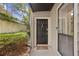 Exterior shot of the front door with a welcome mat and manicured bushes at 407 River Mill Cir # 407, Roswell, GA 30075