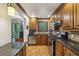 Well-equipped kitchen with granite counters, stainless steel appliances, and tile backsplash at 407 River Mill Cir # 407, Roswell, GA 30075