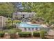 A picturesque pool surrounded by manicured landscaping and a wrought iron fence at 407 River Mill Cir # 407, Roswell, GA 30075